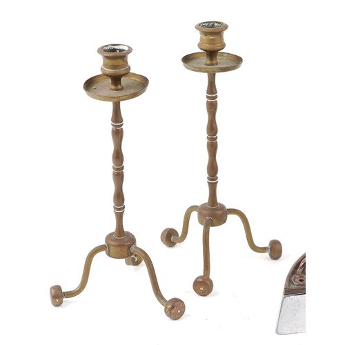 1184 - A set of three early 20th century irons with removable handles together with a pair of brass candles... 