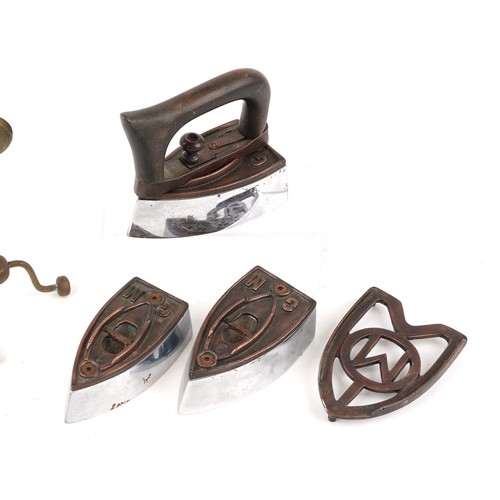 1184 - A set of three early 20th century irons with removable handles together with a pair of brass candles... 