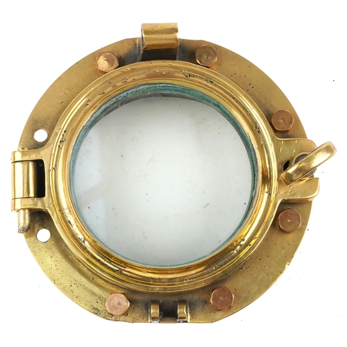 2455 - A shipping interest gilt bronze porthole with bolts, overall 25cm in diameter.