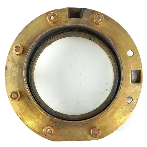 2455 - A shipping interest gilt bronze porthole with bolts, overall 25cm in diameter.