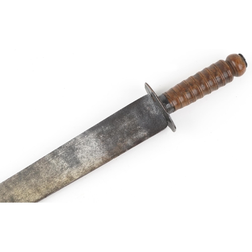 2538 - A military interest machete with turned wooden handle, 59cm in length.