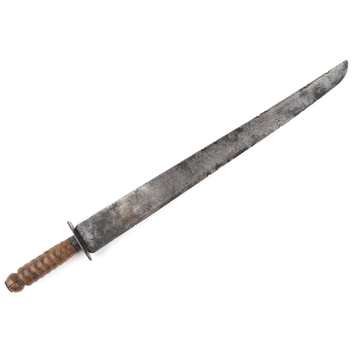 2538 - A military interest machete with turned wooden handle, 59cm in length.