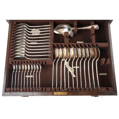 593 - Mappin & Webb, an oak canteen of silver plated cutlery with brass carry handles, 49cm wide.