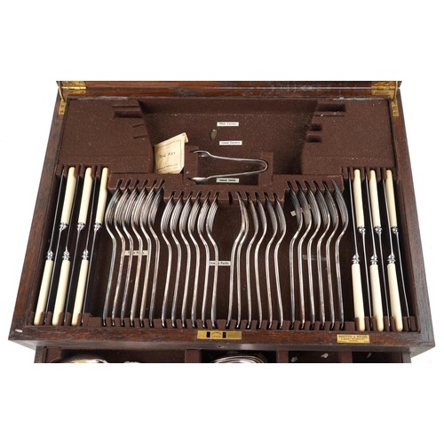 593 - Mappin & Webb, an oak canteen of silver plated cutlery with brass carry handles, 49cm wide.