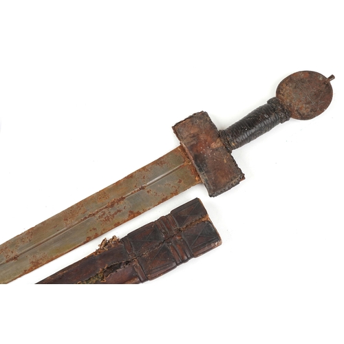 2533 - An antique Middle Eastern short sword with leather sheath, 82cm in length.