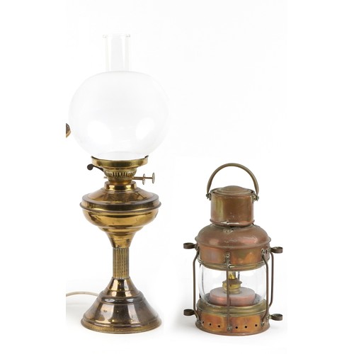 1139 - An early 20th century copper hanging ship's lantern together with a gilt metal oil lamp converted to... 