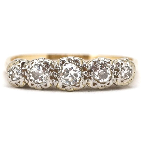 3055 - An 18ct gold and platinum graduated diamond five stone ring, the central diamond approximately 3.0mm... 