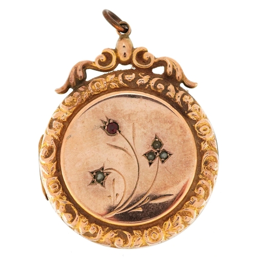 3207 - A large Victorian 9ct gold back and front locket set with a garnet and seed pearls, 4.4cm high, 12.5... 