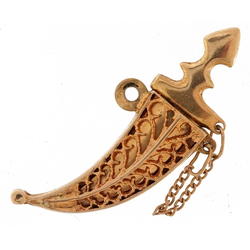  A 9ct gold charm in the form of a Gurkha's kukri knife with sheath, 3.2cm in length, 2.4g.