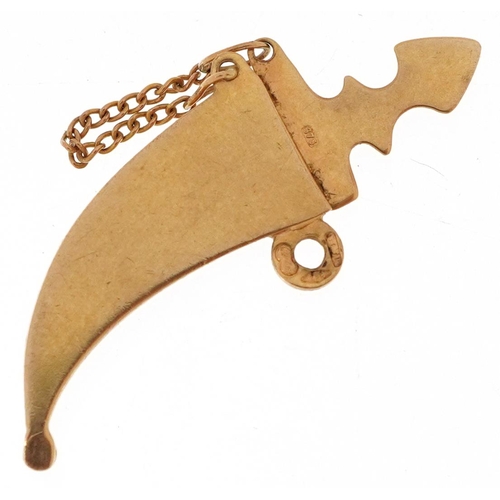  A 9ct gold charm in the form of a Gurkha's kukri knife with sheath, 3.2cm in length, 2.4g.