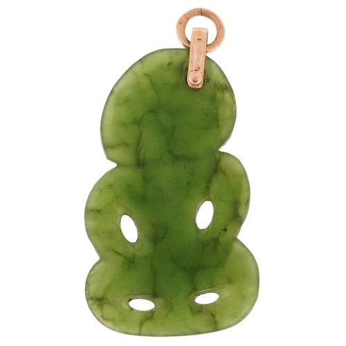  A New Zealand carved green stone Maori pendant with yellow metal mount, 5cm high, 7.3g.