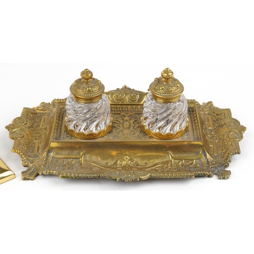 163 - A mid 20th century George III style brass desk stand fitted with two glass inkwells, with scrollwork... 