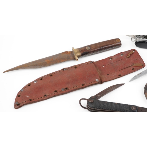 2498 - A group of six folding penknives together with an early 20th wooden handled knife in a leather sheat... 