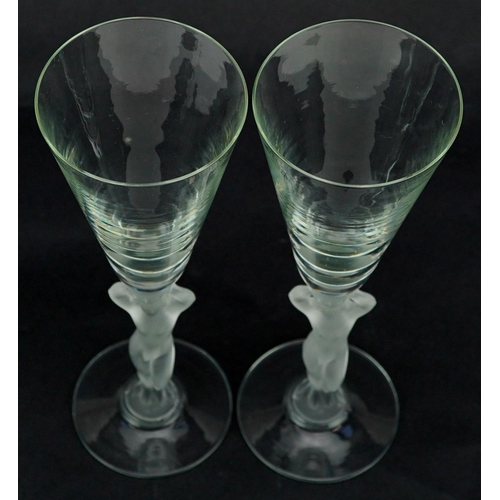 366 - A pair of mid 20th century Bayel frosted crystal Champagne flutes with figural stems, 21cm high.