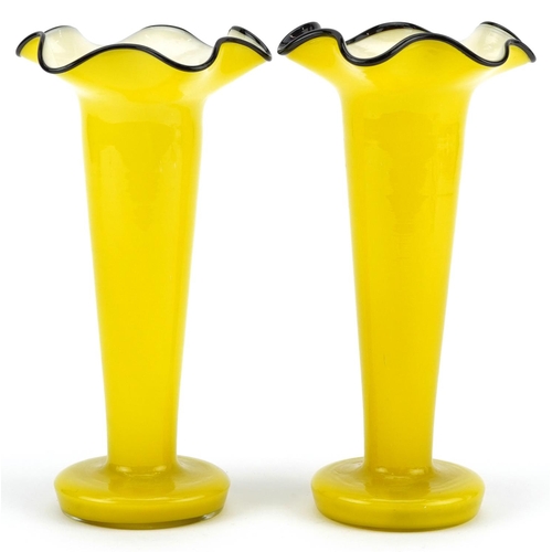 194 - A pair of mid 20th century Bohemian yellow glass Tango vases, 21cm high.