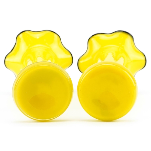 194 - A pair of mid 20th century Bohemian yellow glass Tango vases, 21cm high.