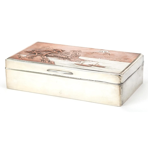  A Japanese silver cigar box, the hinged lid decorated with a view of Mount Fuji, impressed marks to ... 