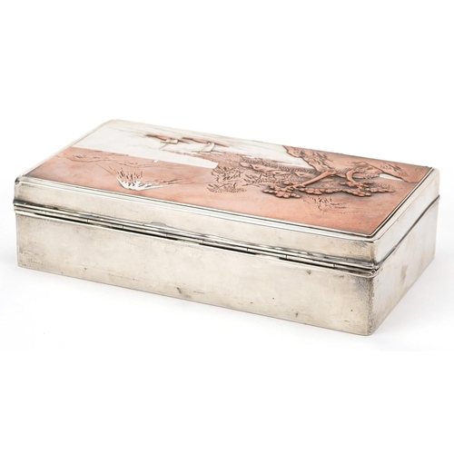  A Japanese silver cigar box, the hinged lid decorated with a view of Mount Fuji, impressed marks to ... 