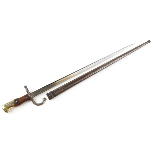 2529 - A French military army M1874 Gras bayonet with scabbard with 1879 inscription to the spine of the bl... 