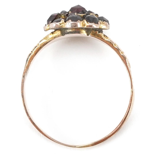 3463 - An antique unmarked gold Bohemian garnet flower head ring with floral engraved shoulders, size U, 3.... 