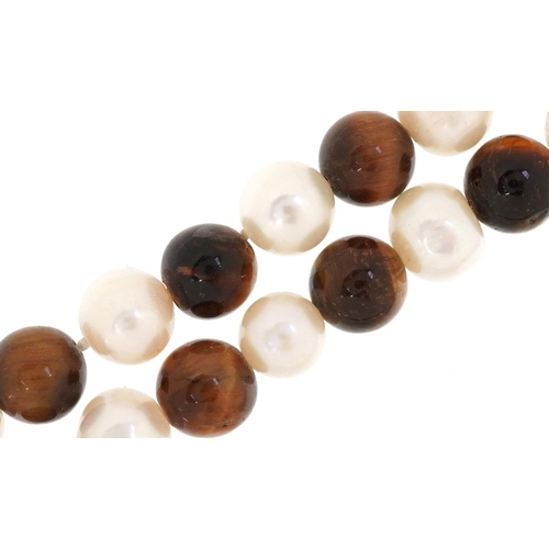 3461 - A freshwater pearl and tiger's eye bead necklace, 120cm in length, 112.8g.