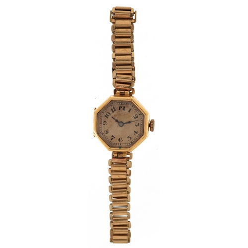 3142 - An Art Deco 18ct gold cased ladies wristwatch with hexagonal dial and gilt metal strap, 21mm wide.