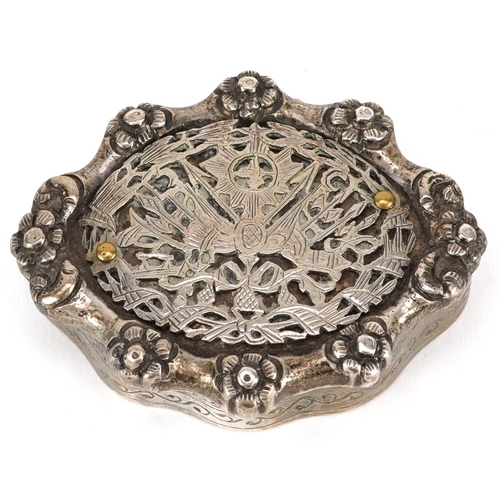 511 - A continental white metal serpentine patch box cast with flower heads, impressed marks to the interi... 