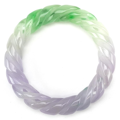 3226 - A Chinese multi coloured jade rope twist design bangle, 9cm in diameter, 90.6g.