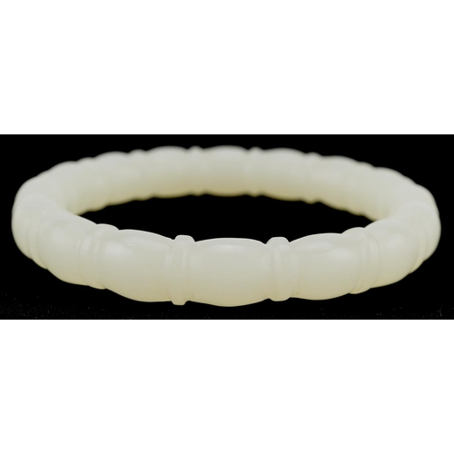 3137 - A Chinese pale green jade bamboo design bangle, 8cm in diameter, 43.0g.