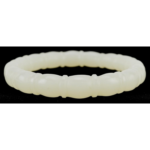 3137 - A Chinese pale green jade bamboo design bangle, 8cm in diameter, 43.0g.