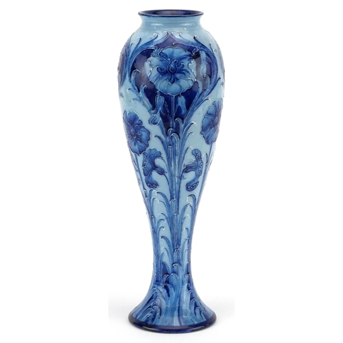 William Moorcroft, a Florian Ware Macintyre vase hand painted with blue stylised flowers, 29cm high.