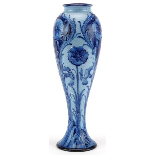  William Moorcroft, a Florian Ware Macintyre vase hand painted with blue stylised flowers, 29cm high.