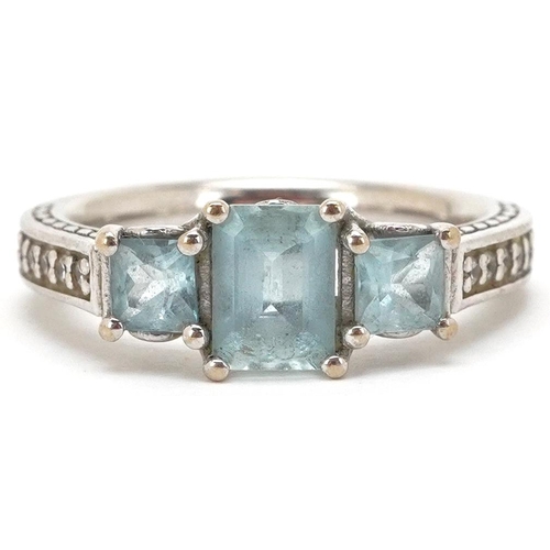 3141 - A 9ct white gold aquamarine three stone ring with clear stone set shoulders, size P, 4.5g.