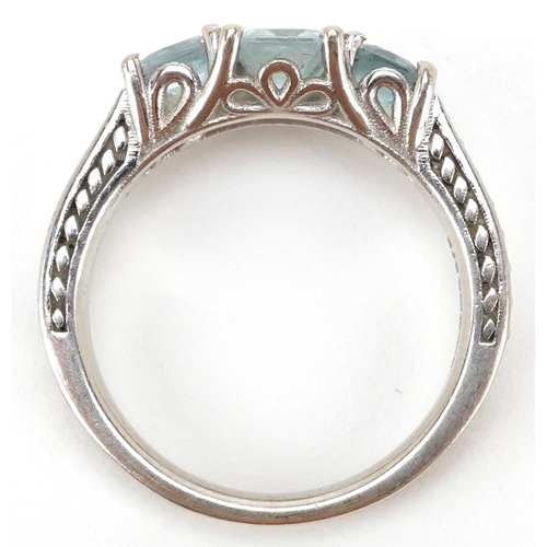 3141 - A 9ct white gold aquamarine three stone ring with clear stone set shoulders, size P, 4.5g.