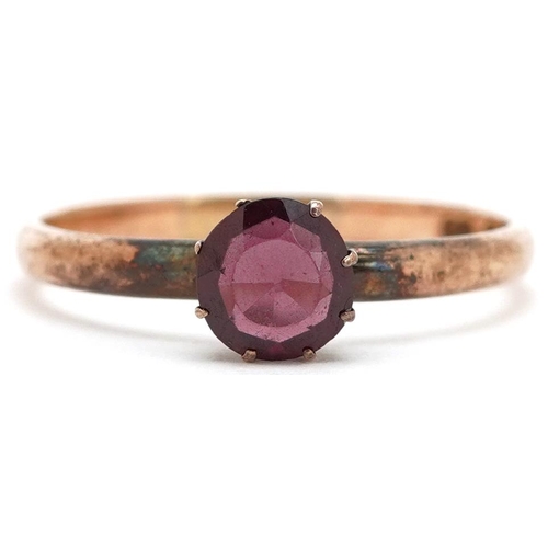 3106 - A 9ct gold garnet solitaire ring, size U, 2.1g.