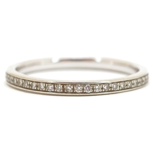 3113 - An unmarked 9ct white gold diamond eternity ring, size P, 1.8g.