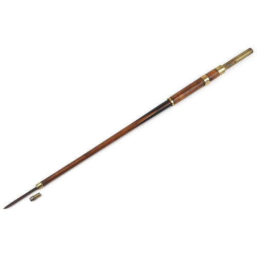 132A - A 19th century mahogany propelling swordstick with brass mounts and ebonised decoration, 90cm in len... 