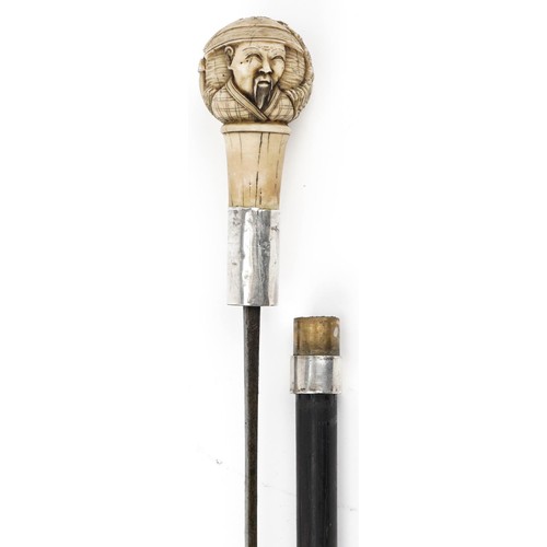 132B - A 19th century hardwood sword stick with a carved bone pommel and silver mount, 84cm in length.