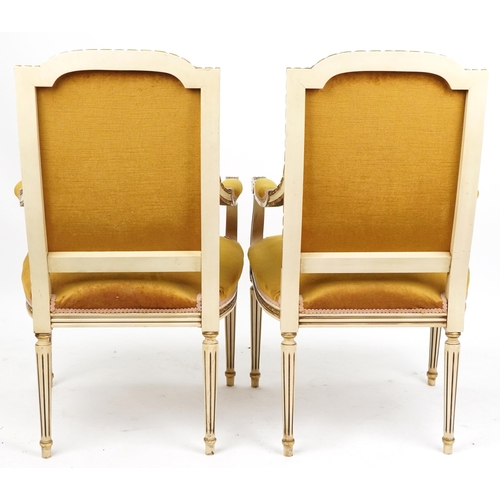 2019 - A pair of 20th century French cream and gilt painted salon armchairs upholstered in golden velour, r... 