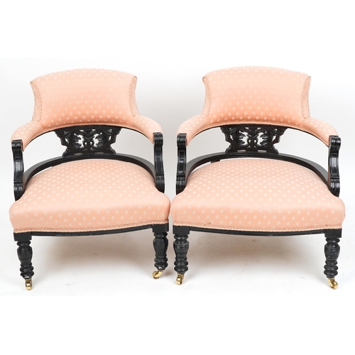 2021 - A pair of Edwardian ebonised tub back salon armchairs upholstered in pink fabric, 70cm high x 58cm w... 