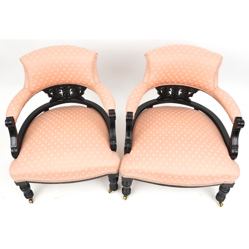 2021 - A pair of Edwardian ebonised tub back salon armchairs upholstered in pink fabric, 70cm high x 58cm w... 