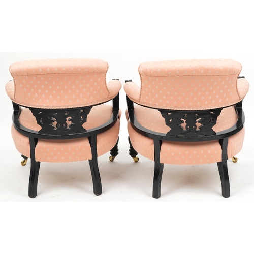 2021 - A pair of Edwardian ebonised tub back salon armchairs upholstered in pink fabric, 70cm high x 58cm w... 