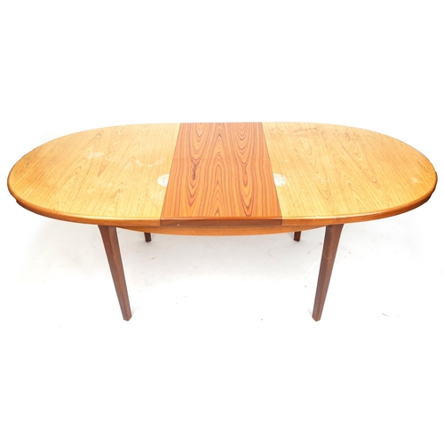 2031 - A mid/late 20th century G Plan teak extending dining table with single extra leaf, together with six... 