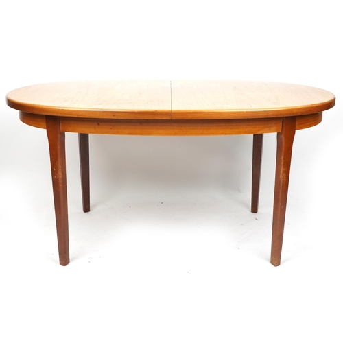 2031 - A mid/late 20th century G Plan teak extending dining table with single extra leaf, together with six... 