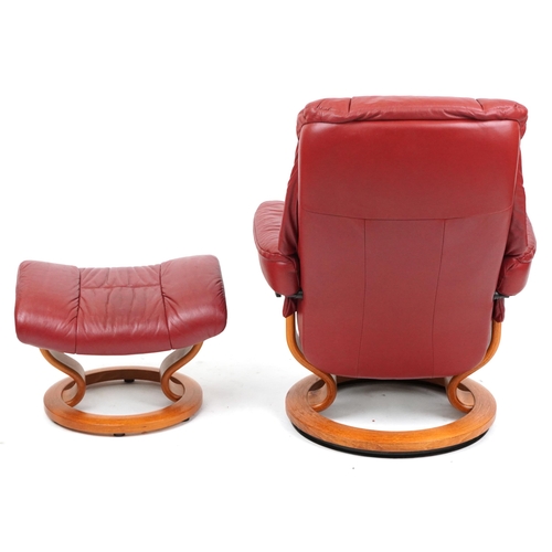 2014 - An Ekornes Stressless red leather armchair and footstool, 100cm high x 78cm wide.