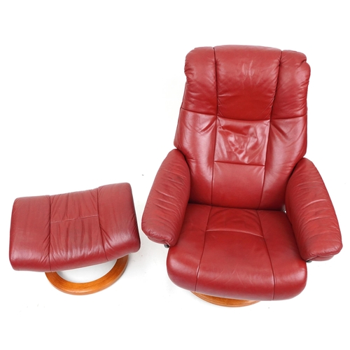 2014 - An Ekornes Stressless red leather armchair and footstool, 100cm high x 78cm wide.