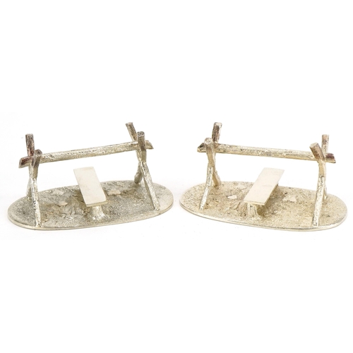 512 - A pair of plated knife rests, circa 1880, in the form of a stile, with oval grassy textured plinth, ... 