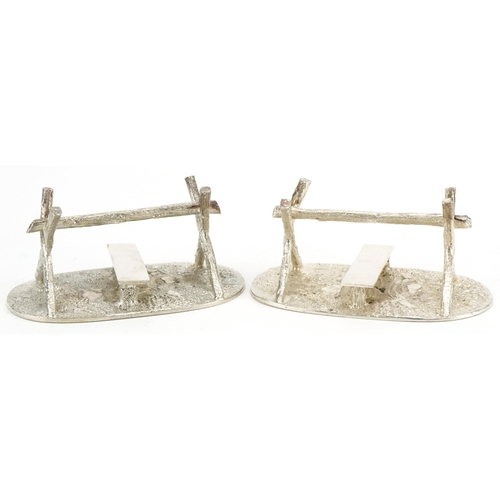 512 - A pair of plated knife rests, circa 1880, in the form of a stile, with oval grassy textured plinth, ... 