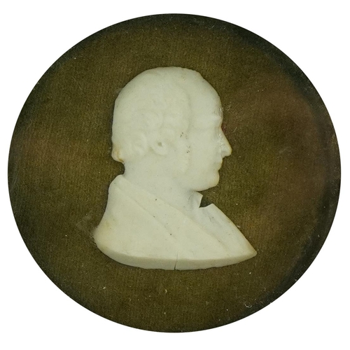 324 - A mahogany framed wax silhouette of a man, dated 1854, on green plush, 8.5 cm diameter, inscribed ve... 