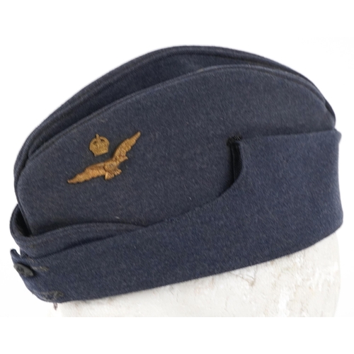 2478 - RAF military officer's side cap dated 1945 and a pair of shoulder badges.